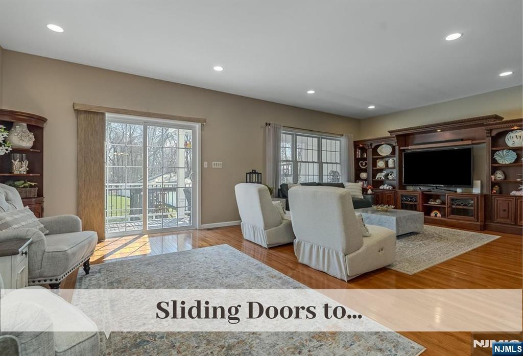 80 West Prospect Street Waldwick, NJ 07463 - Photo 19 of 50 a living room with furniture a flat screen tv and a large window