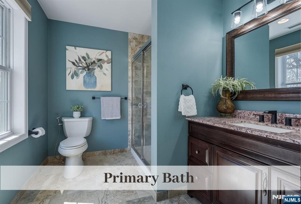 80 West Prospect Street Waldwick, NJ 07463 - Photo 27 of 50 a bathroom with a toilet a sink and mirror