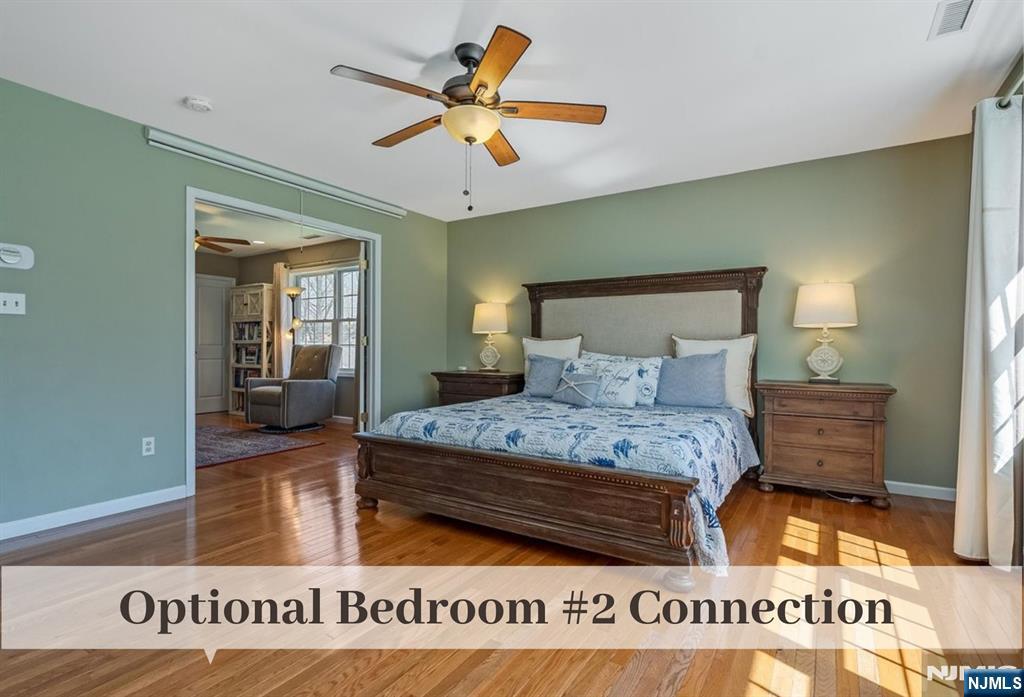 80 West Prospect Street Waldwick, NJ 07463 - Photo 28 of 50 a bedroom with a large bed and a chandelier