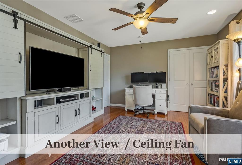 80 West Prospect Street Waldwick, NJ 07463 - Photo 30 of 50 a living room with furniture and a flat screen tv