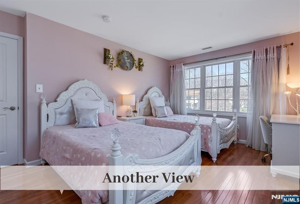 80 West Prospect Street Waldwick, NJ 07463 - Photo 32 of 50 a bedroom with a bed and wooden floor