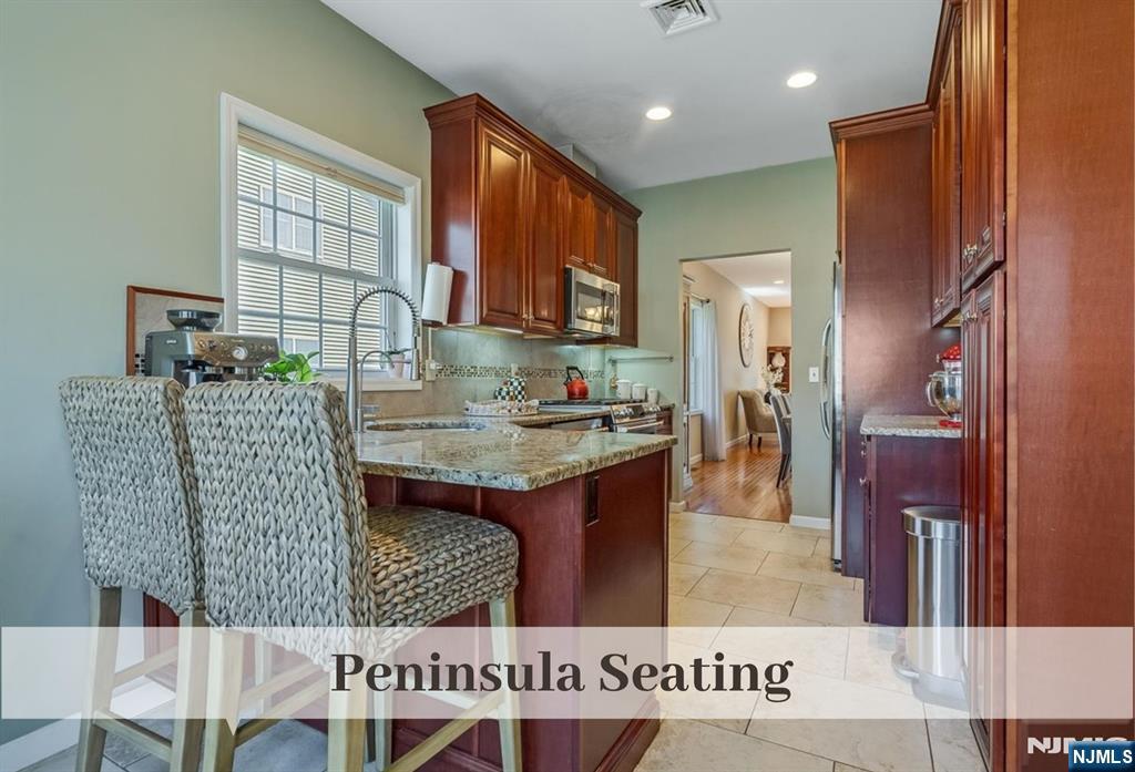 80 West Prospect Street Waldwick, NJ 07463 - Photo 6 of 50 a kitchen view with granite countertop a table chairs and a refrigerator