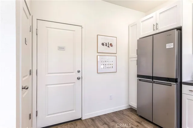 a view of a refrigerator in kitchen and wooden floor