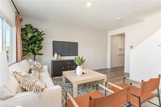 a living room with furniture potted plant and a window