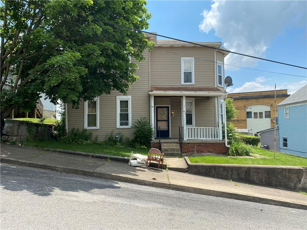 411 East Washington Street Rochester, PA 15074 - Photo 2 of 11 a front view of a house with a yard and garage