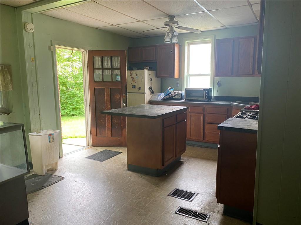 411 East Washington Street Rochester, PA 15074 - Photo 6 of 11 a kitchen with cabinets a sink a window and appliances