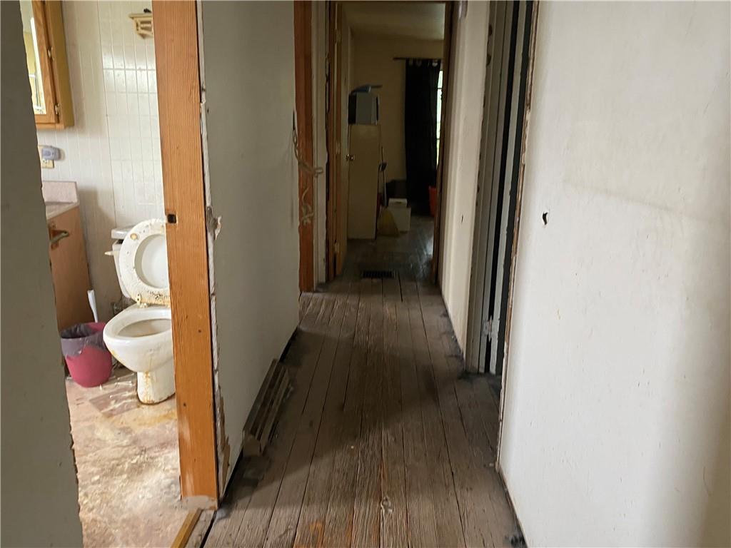 411 East Washington Street Rochester, PA 15074 - Photo 7 of 11 a view of a hallway with wooden floor and a living room