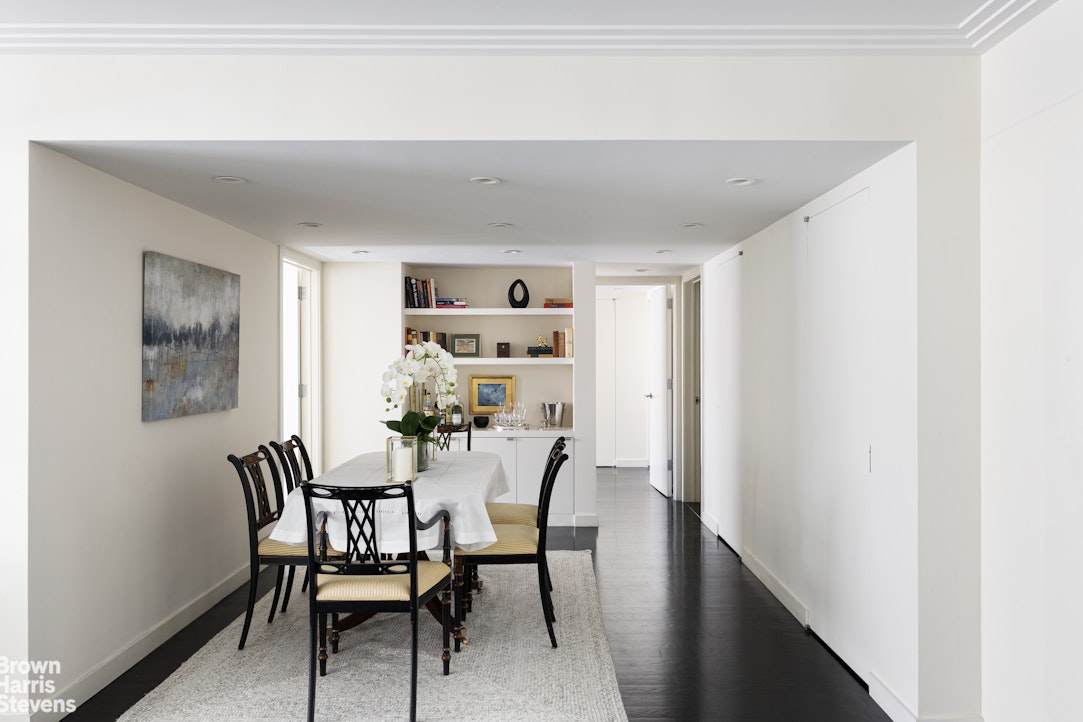 27 East 65th Street, Unit 11D Manhattan, NY 10065 - Photo 5 of 15 a dining room with furniture and window