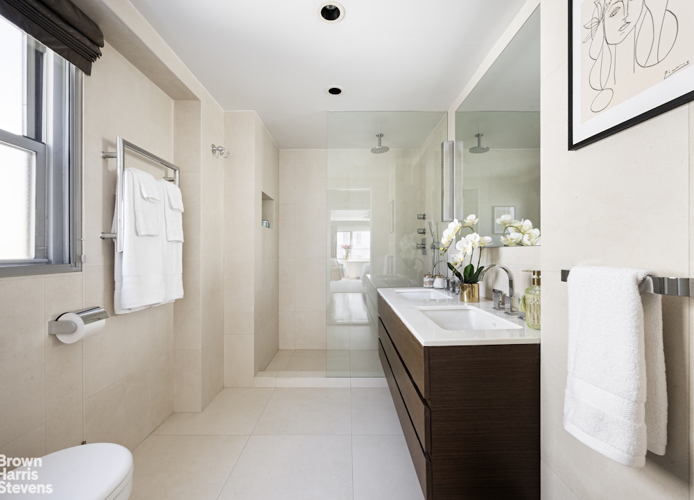 27 East 65th Street, Unit 11D Manhattan, NY 10065 - Photo 9 of 15 a bathroom with a sink toilet and shower