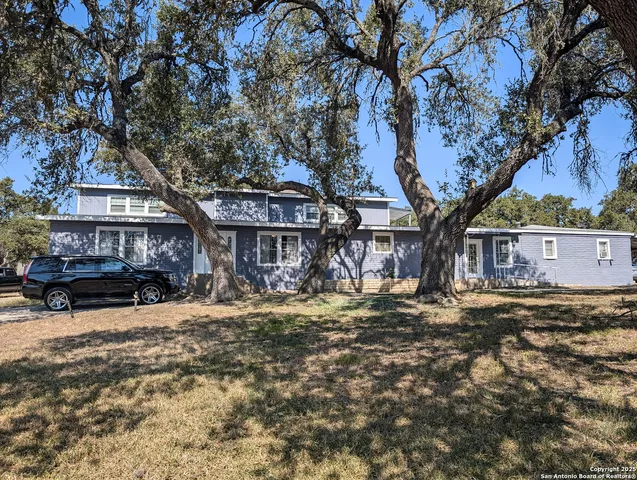 a view of a house with a yard covered with snow in the background