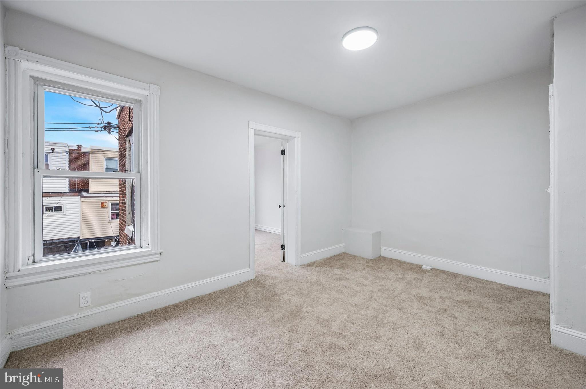 2433 South Millick Street Philadelphia, PA 19142 - Photo 14 of 15 an empty room with windows and closet