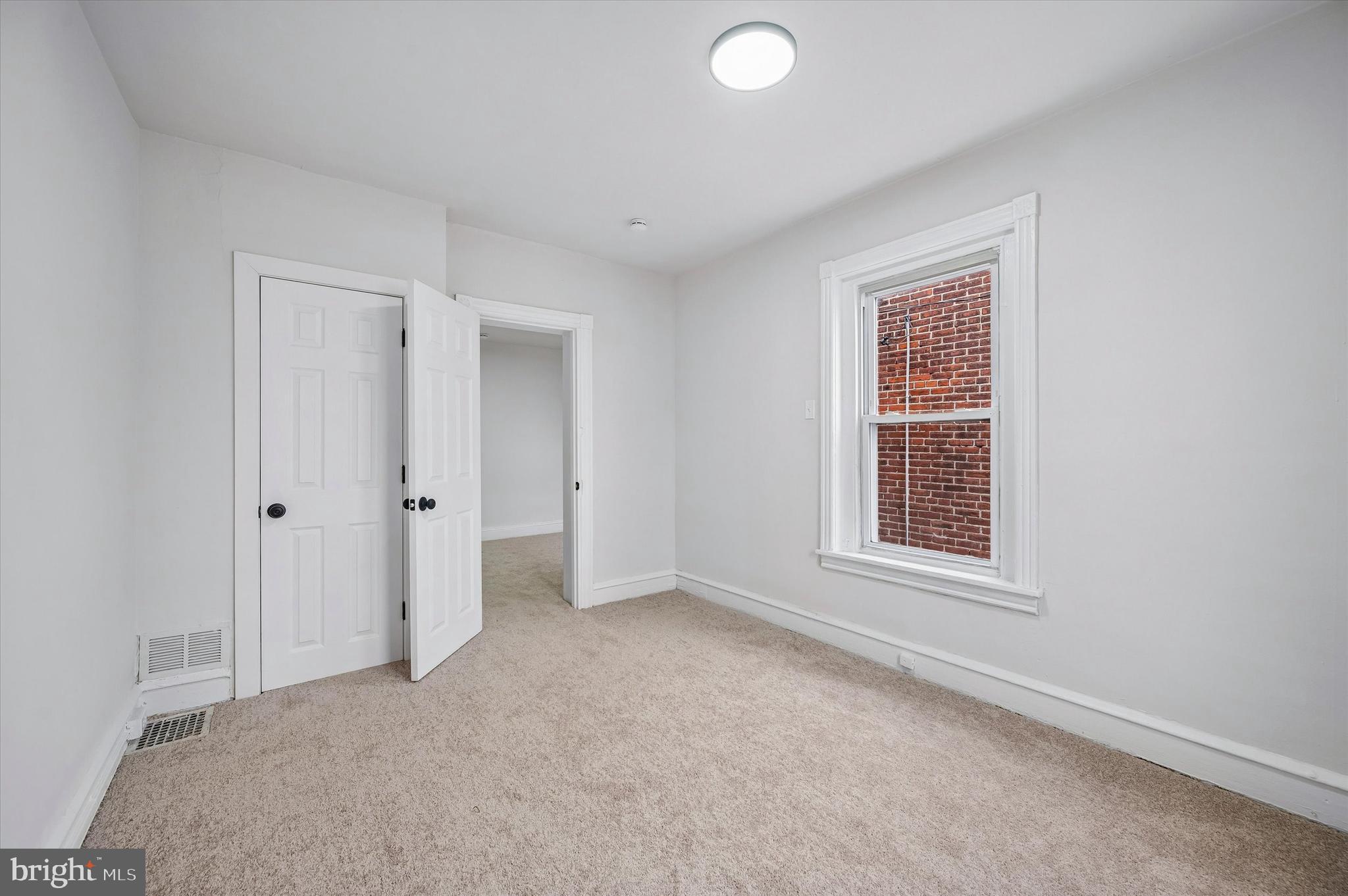 2433 South Millick Street Philadelphia, PA 19142 - Photo 15 of 15 an empty room with windows and closet