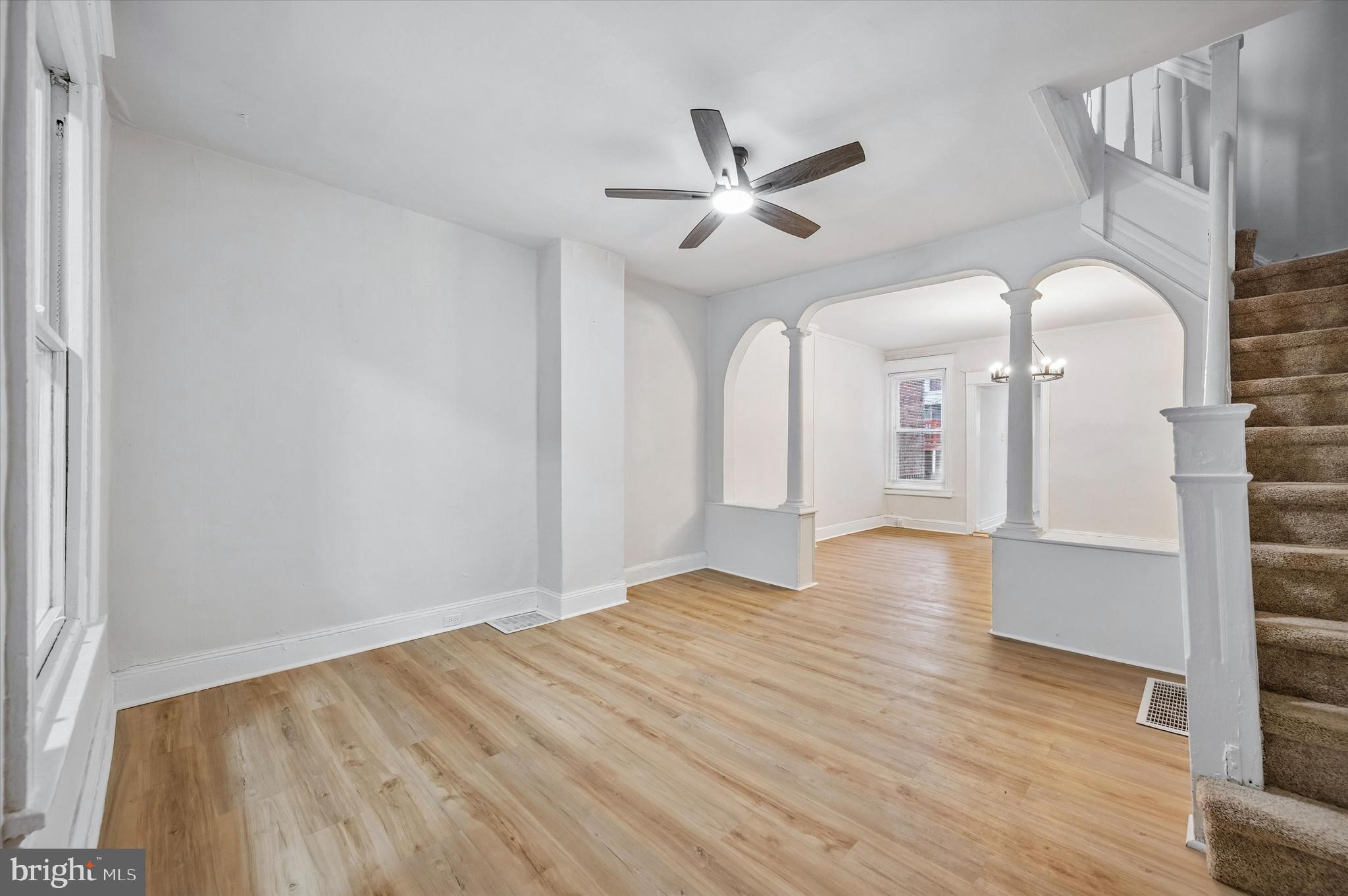 2433 South Millick Street Philadelphia, PA 19142 - Photo 3 of 15 a view of an empty room with wooden floor and a window