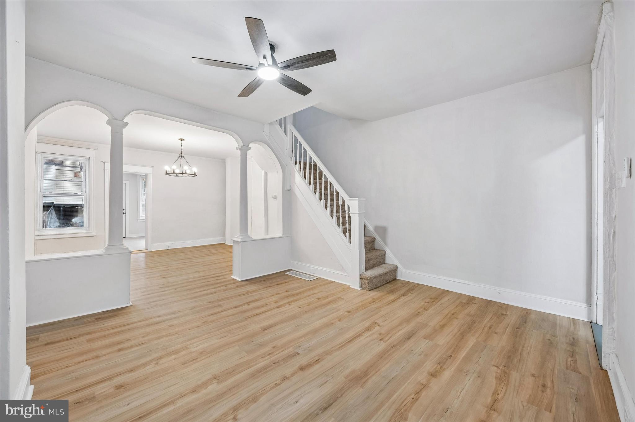 2433 South Millick Street Philadelphia, PA 19142 - Photo 4 of 15 wooden floor in an empty room with a window