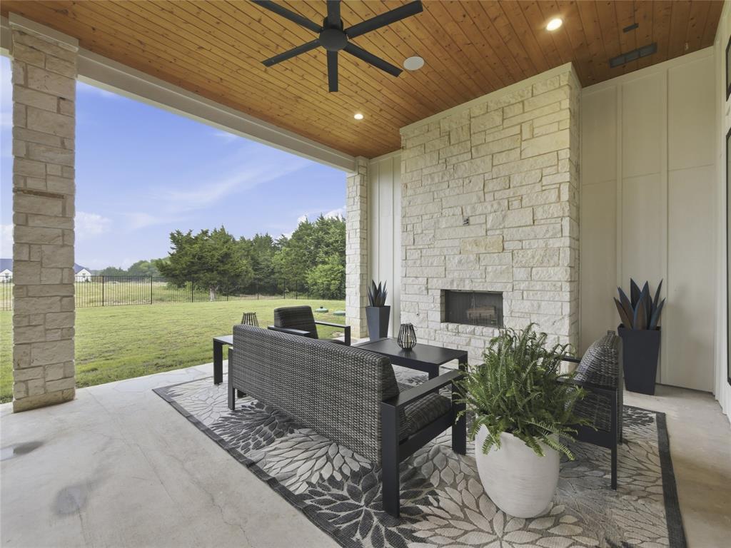 4211 Azalea Way Midlothian, TX 76065 - Photo 36 of 39 Covered patio featuring a stone fireplace, wood-plank ceiling with a ceiling fan, and recessed lighting