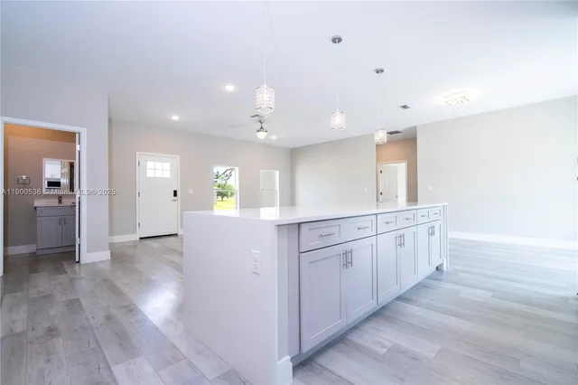 a view of kitchen with center island and wooden floor
