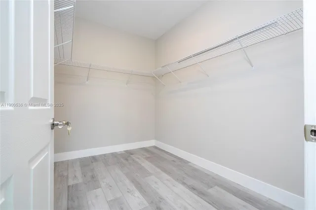 a view of a room with wooden floor