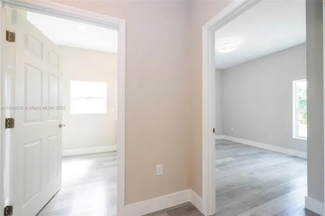 a view of a bathroom with a glass door and a window