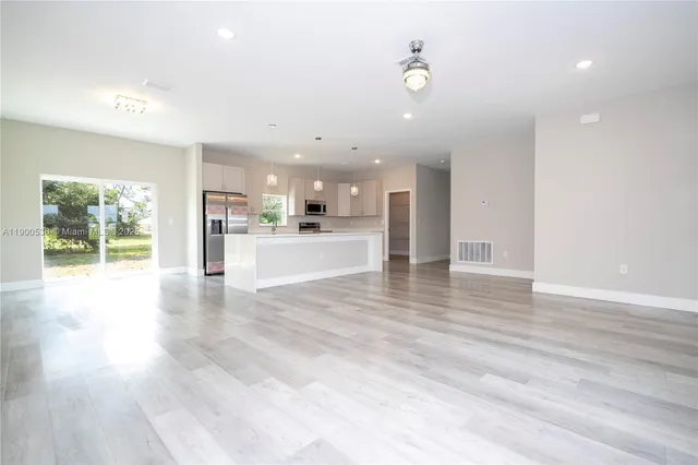 a view of kitchen with cabinets and wooden floor