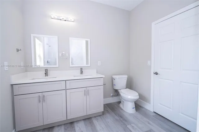 a bathroom with a toilet sink and a mirror