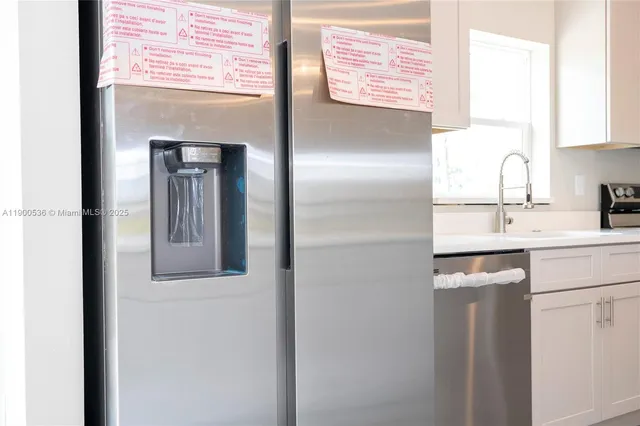 a kitchen with a refrigerator and sink