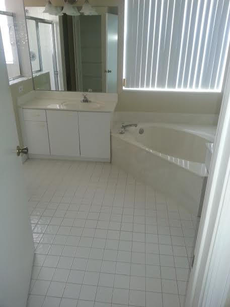 7434 Michigan Isle Road Lake Worth, FL 33467 - Photo 15 of 23 a bathroom with a bathtub and shower