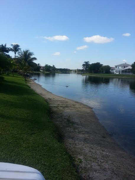 7434 Michigan Isle Road Lake Worth, FL 33467 - Photo 19 of 23 a view of a lake with houses in background
