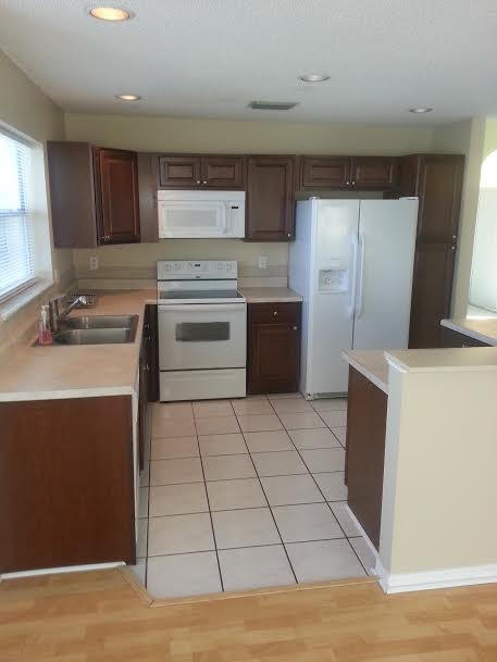 7434 Michigan Isle Road Lake Worth, FL 33467 - Photo 6 of 23 a kitchen with stainless steel appliances a sink stove and refrigerator