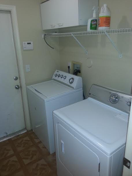 7434 Michigan Isle Road Lake Worth, FL 33467 - Photo 7 of 23 a utility room with dryer and washer