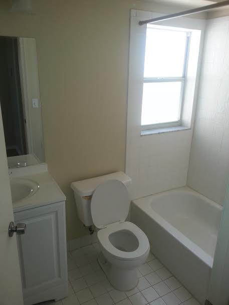 7434 Michigan Isle Road Lake Worth, FL 33467 - Photo 8 of 23 a white toilet sitting next to a window