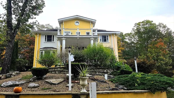 a front view of a house with yard
