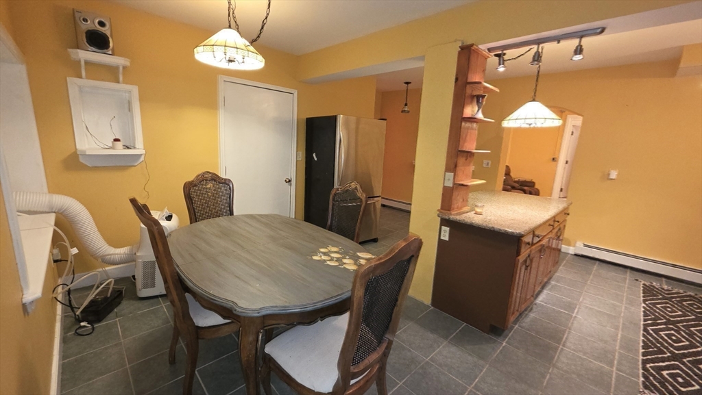 85 Burlingame Road, Unit 1 Charlton, MA 01507 - Photo 12 of 31 a view of a dining room with furniture and wooden floor