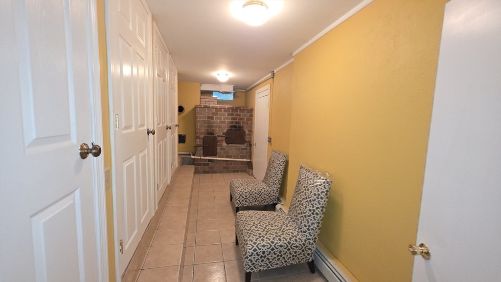 85 Burlingame Road, Unit 1 Charlton, MA 01507 - Photo 15 of 31 a hallway with furniture and wooden floor