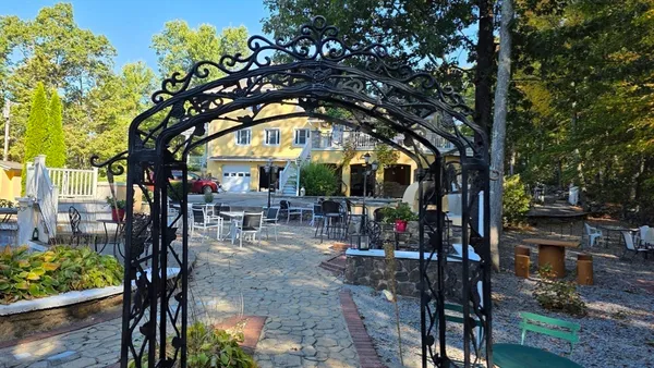 a view of a patio with dining table and chairs with wooden floor and fence