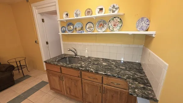 a bathroom with a stove and a mirror
