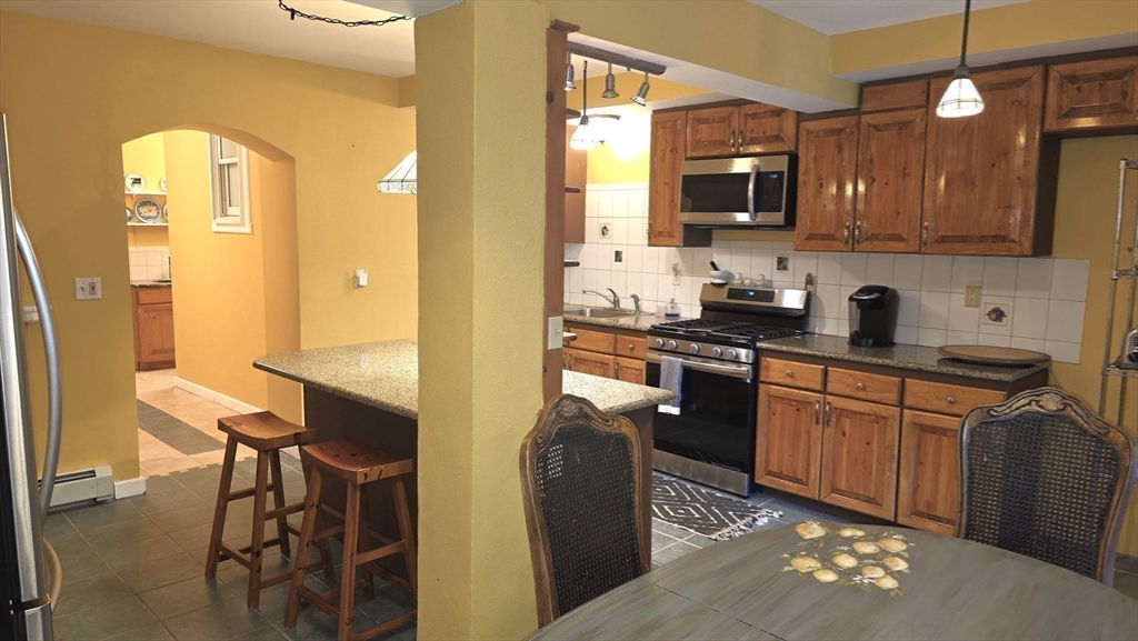 85 Burlingame Road, Unit 1 Charlton, MA 01507 - Photo 9 of 31 a kitchen with stainless steel appliances granite countertop a refrigerator a stove top oven a sink and dishwasher