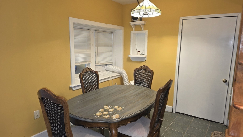 85 Burlingame Road, Unit 1 Charlton, MA 01507 - Photo 10 of 31 a view of a dining room with furniture and chandelier