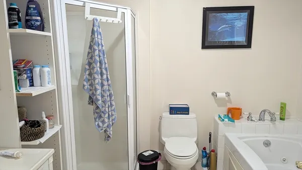 a bathroom with a toilet and a shower curtain