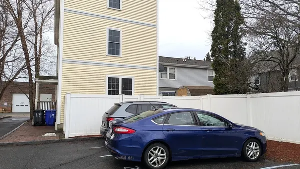 a front view of a house with parking space