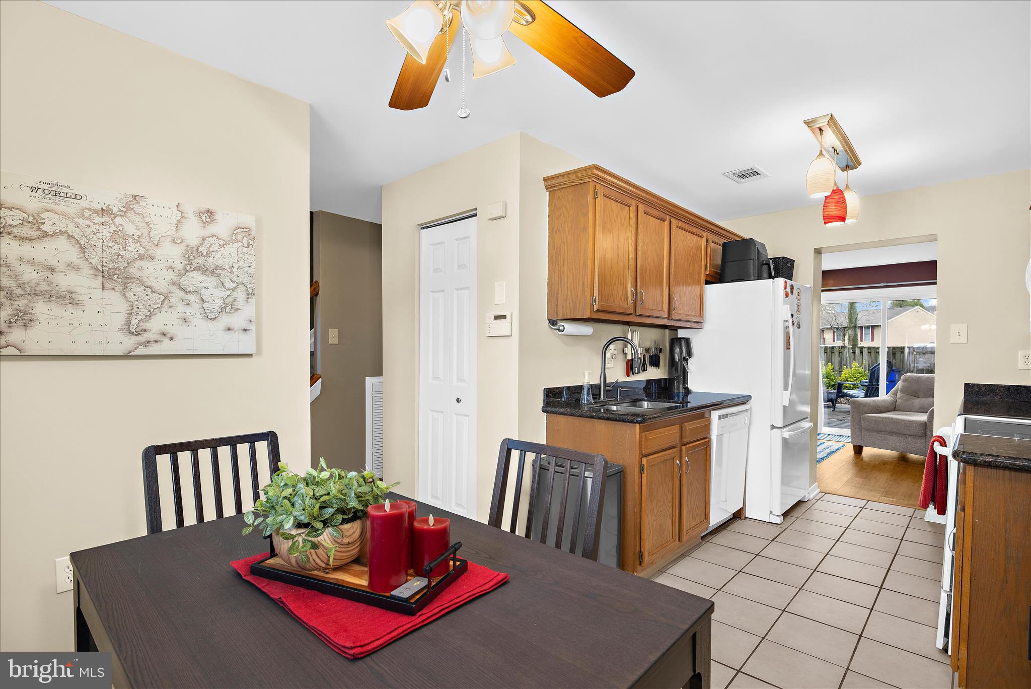 47 Vienna Court Frederick, MD 21702 - Photo 11 of 47 a living room with stainless steel appliances kitchen island granite countertop a table chairs in it and wooden floors