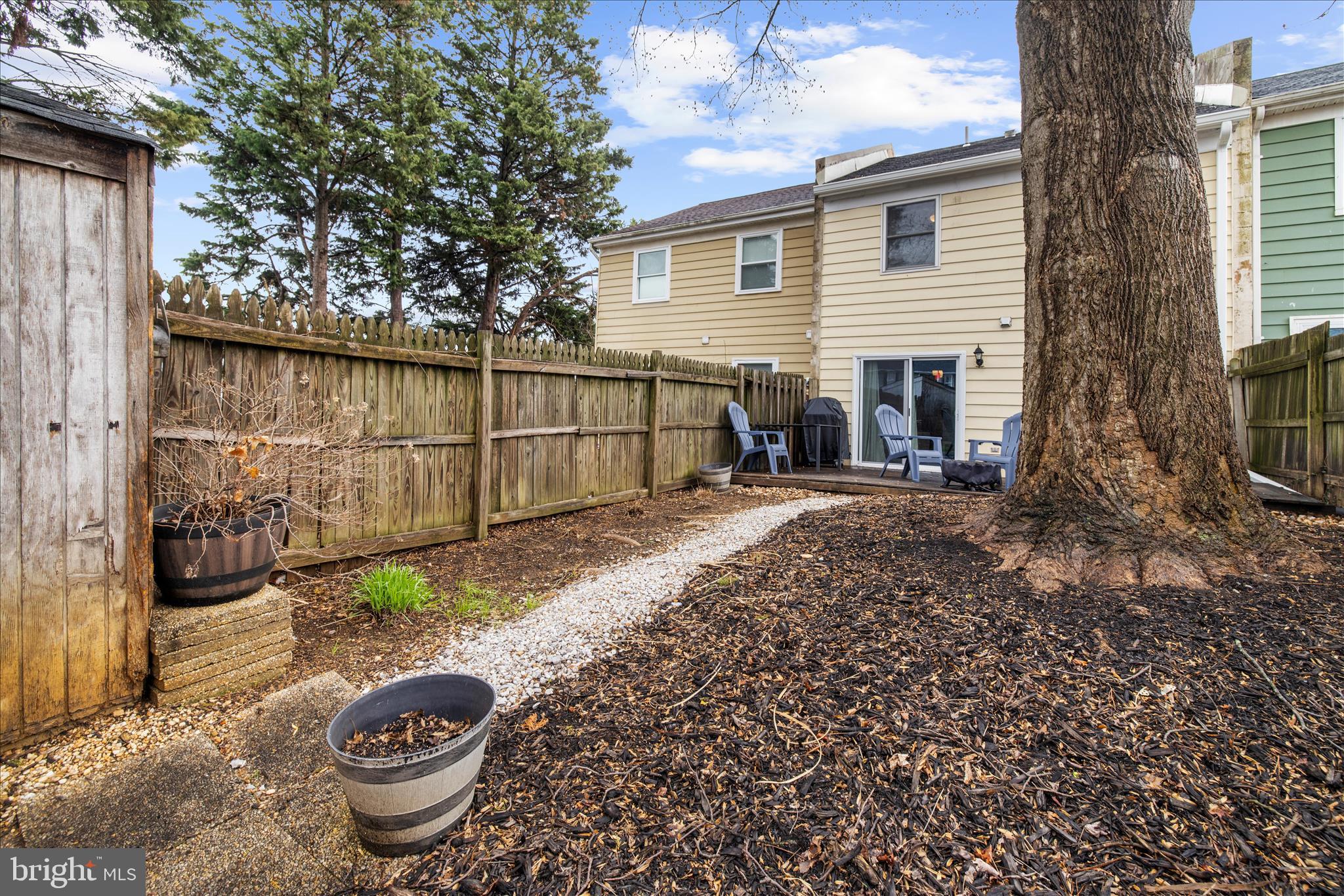 47 Vienna Court Frederick, MD 21702 - Photo 35 of 47 a view of a backyard with table and chairs potted plants and tree