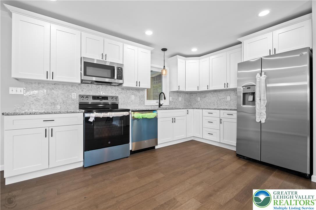 1111 Delabole Jct Road Pen Argyl, PA 18072 - Photo 11 of 26 a kitchen with stainless steel appliances and white cabinets