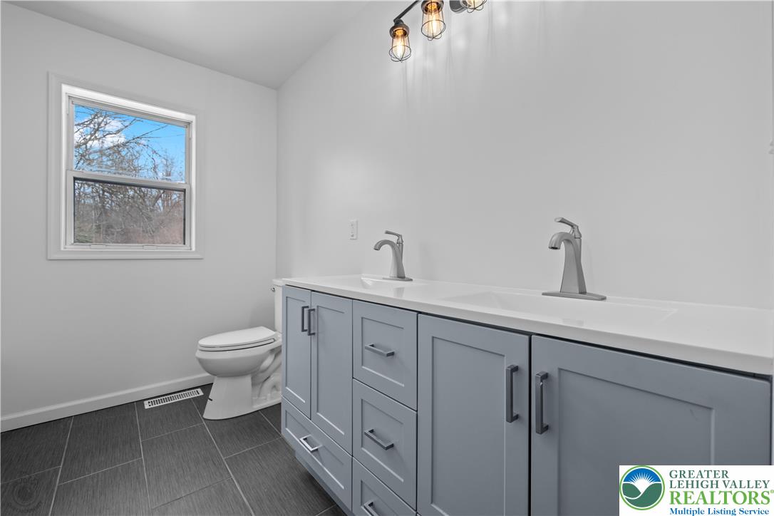 1111 Delabole Jct Road Pen Argyl, PA 18072 - Photo 14 of 26 a bathroom with a toilet sink and mirror