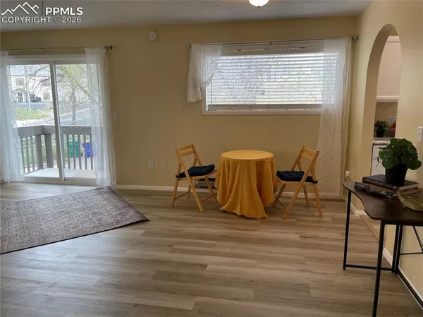 a view of a workspace with furniture and a window