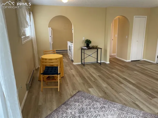 a view of a livingroom with furniture and staircase