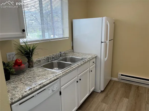 a kitchen with a refrigerator and a sink