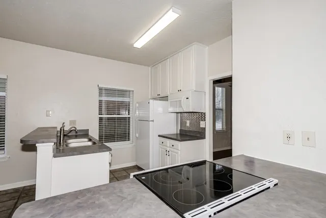 a kitchen with stainless steel appliances granite countertop a sink and a stove
