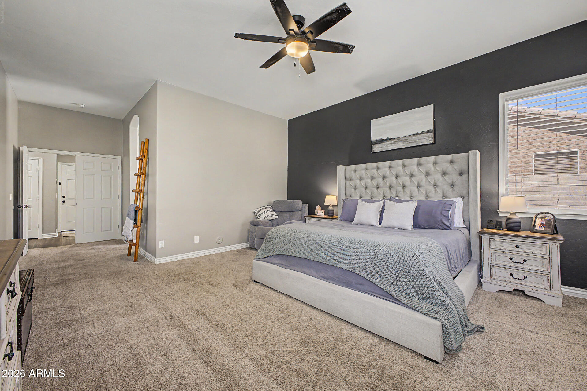 2065 South Porter Street Gilbert, AZ 85295 - Photo 19 of 36 a bedroom with a large bed and a chandelier