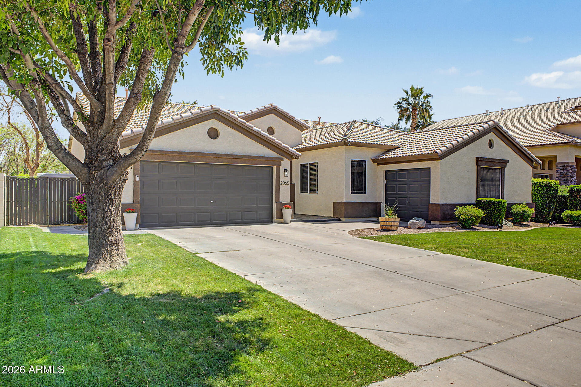 2065 South Porter Street Gilbert, AZ 85295 - Photo 2 of 36 a front view of a house with a yard and garage