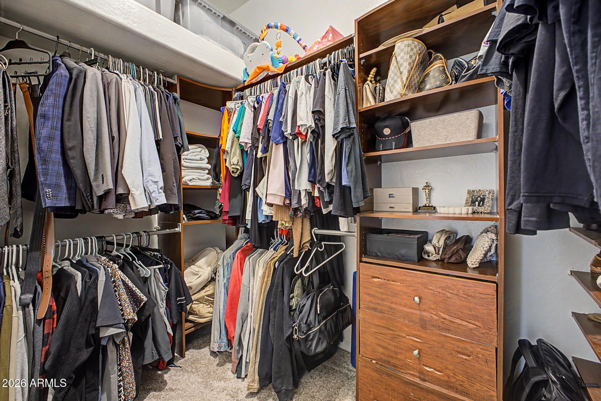 2065 South Porter Street Gilbert, AZ 85295 - Photo 23 of 36 a view of walk in closet with clothes and shoes